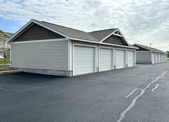 Detached garage building with multiple single car bays at Copper Creek Homes Apartments, Maize