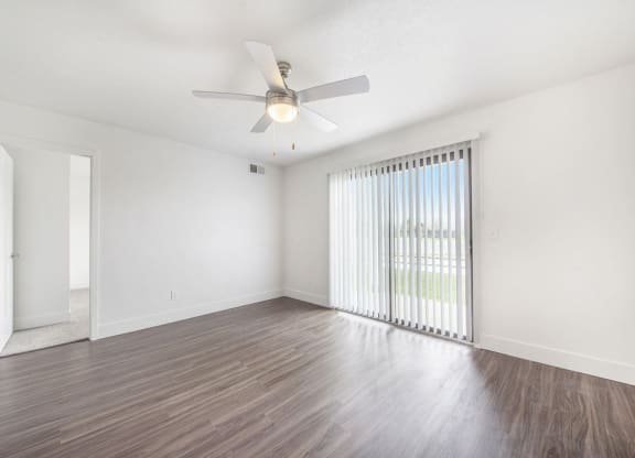 Renovated Living Room Leads To Patio at The Crossings Apartments, Grand Rapids, Michigan