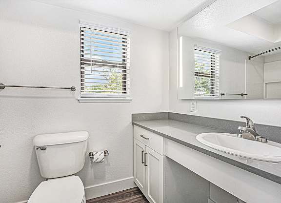 a bathroom with a window at The Crossings Apartments, Michigan, 49508