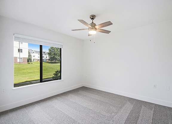 Spacious bedroom with large window at The Crossings Apartments, Grand Rapids, Michigan