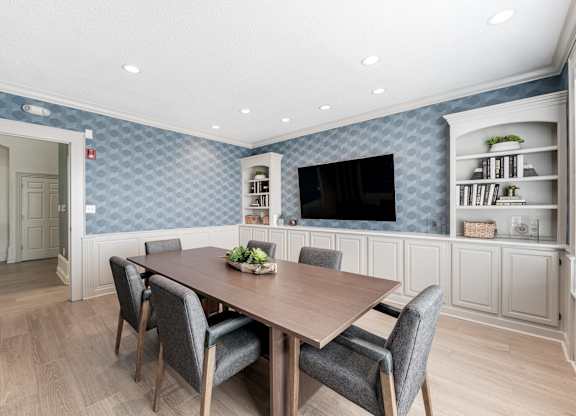 a dining room with a table and chairs at Latitudes Apartments, Indianapolis