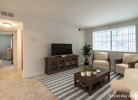 A living room with a television, chairs, and a coffee table at Beacon Hill and Great Oaks Apartments, Rockford, Illinois