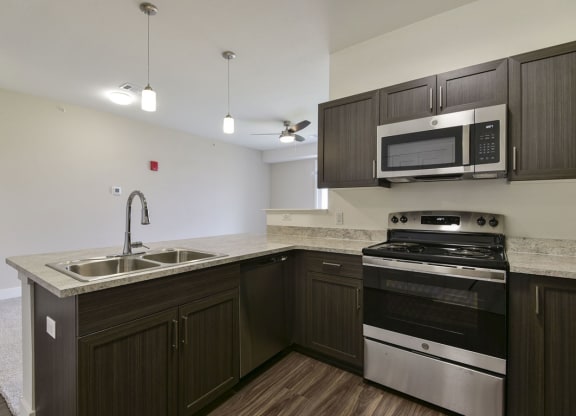 Kitchen with Breakfast Bar at Dodson Pointe Apartment Homes, Rogers, AR, 72758