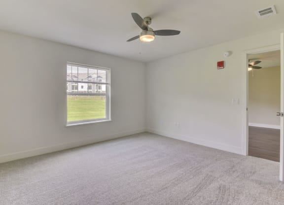 Master Bedroom with Ceiling Fan at Dodson Pointe Apartment Homes, Rogers, AR, 72758