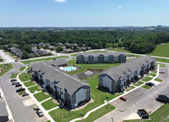 an aerial view of an apartment complex and parking lot at Dodson Pointe Apartment Homes, Rogers