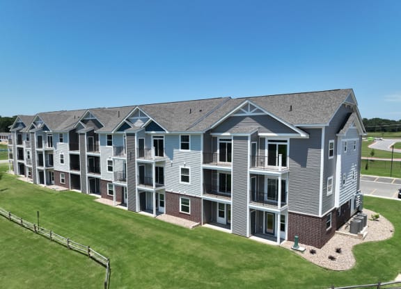 an aerial view of an apartment building with green grass at Dodson Pointe Apartment Homes, Rogers, AR, 72758