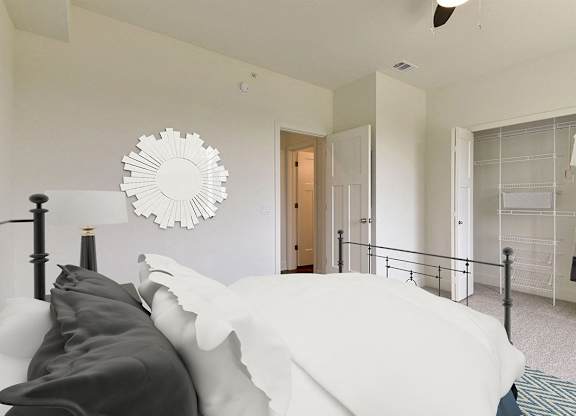 A bedroom with a bed and a walk in closet at Dodson Pointe Apartment Homes, Rogers