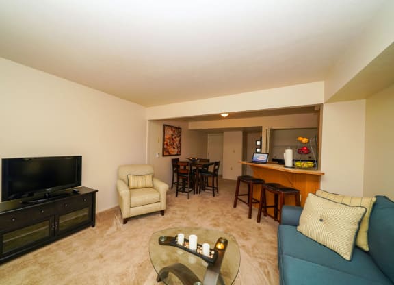 A living room leading to a dining room and kitchen at Dupont Lakes Apartments, Fort Wayne 46825