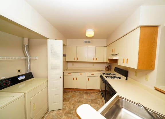 Kitchen with Washer Dryer Set at Dupont Lakes Apartments, Fort Wayne, Indiana