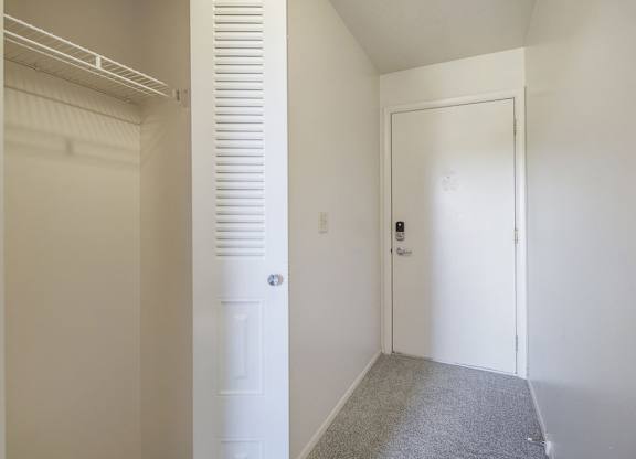 A entryway with a white closet at Dupont Lakes Apartments, Fort Wayne