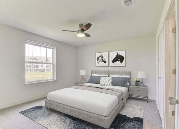 Bedroom with large window and ceiling fan at Eagle Ridge Apartment Homes, Traverse City, MI