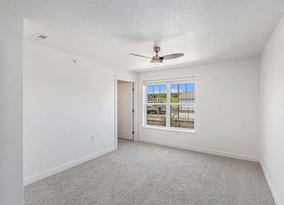 Spacious bedroom with large windows and walk in closet at Eagle Ridge Apartment Homes,  Michigan 49685