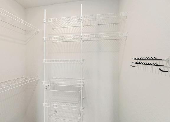 A walk in closet with wardrobe organizers at Eagle Ridge Apartment Homes, Traverse City, MI 49685