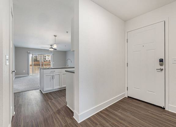 An entryway leading to a kitchen and living room Spacious bedroom with large windows and walk in closet at Eagle Ridge Apartment Homes,  Michigan 49685