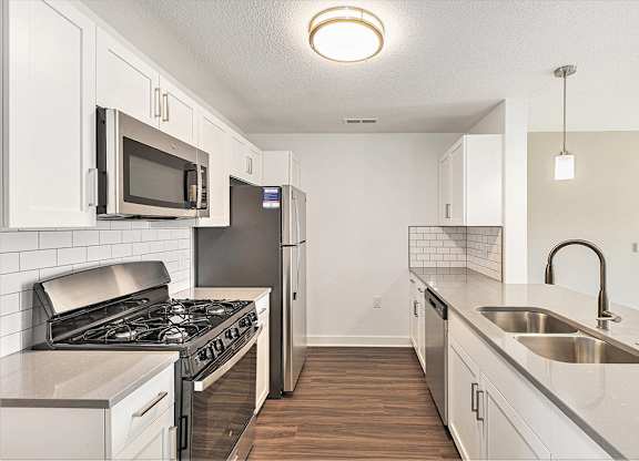 A kitchen with a white cabinets and stainless steel appliances at Eagle Ridge Apartment Homes, Traverse City, Michigan