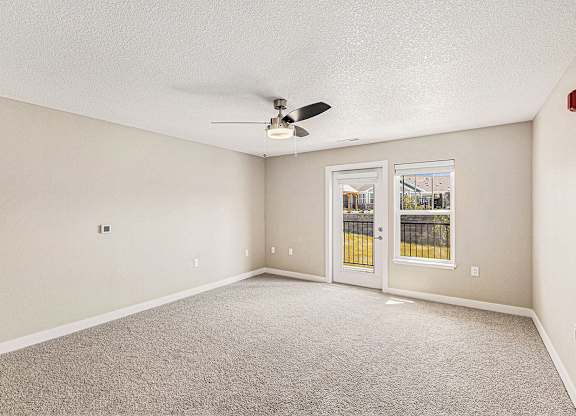 Two bedroom living room with ceiling fan at Eagle Ridge Apartment Homes, Traverse City
