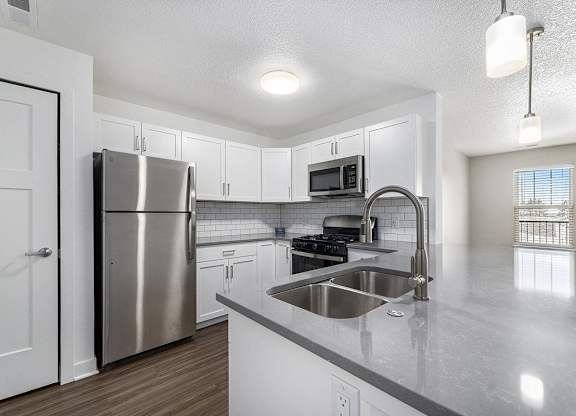 Kitchen with white shaker style cabinets and stainless steel appliances  at Eagle Ridge Apartment Homes, Traverse City, Michigan