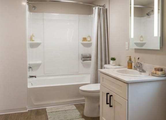 A white bathroom with a toilet, sink, and bathtub.