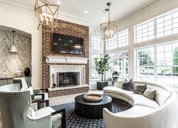 a couch and fireplace in the clubhouse  at Alexandria of Carmel Apartments, Carmel