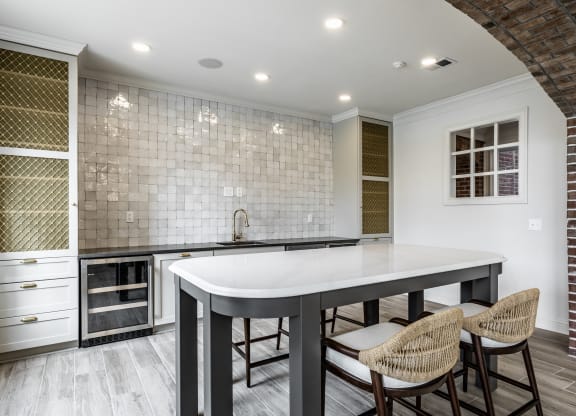 Kitchenette with island and tile backsplash at Alexandria of Carmel Apartments, Carmel