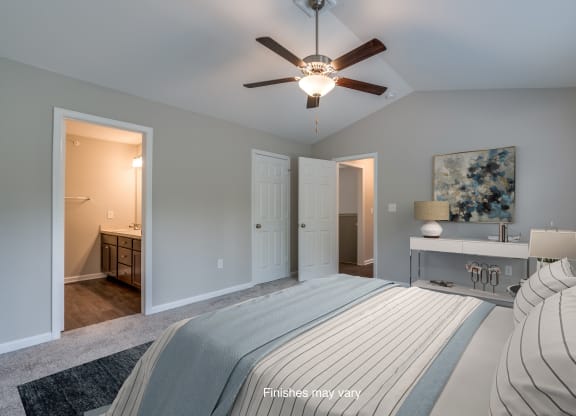 a bedroom with a large bed and a ceiling fan  at Killian Lakes Apartments and Townhomes, South Carolina
