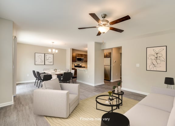 a living room and dining room with a ceiling fan  at Killian Lakes Apartments and Townhomes, Columbia