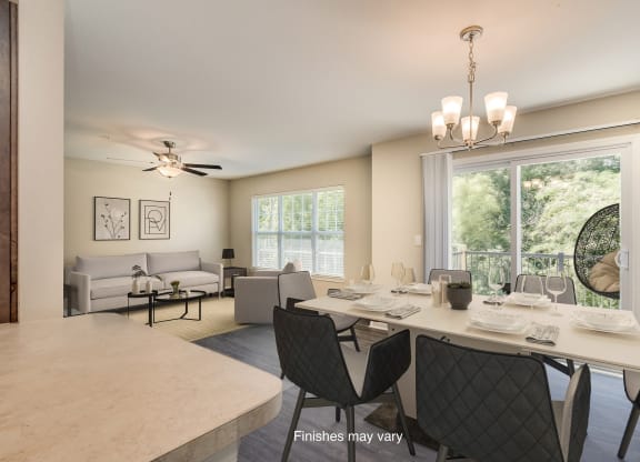 an open living room and dining room with a large window  at Killian Lakes Apartments and Townhomes, Columbia