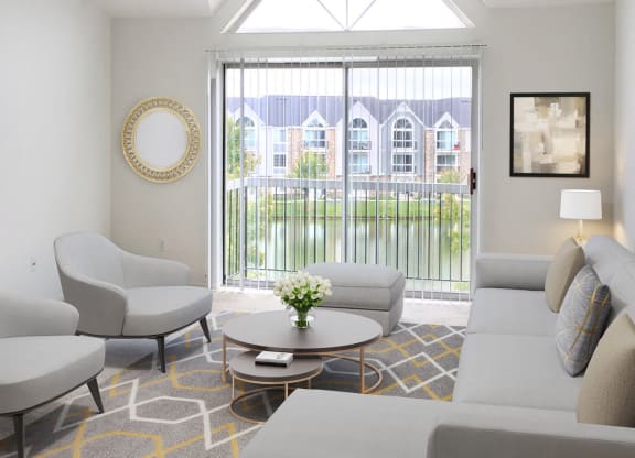 a living room with couches and chairs and a large window at LakePointe Apartments, Batavia, OH, 45103