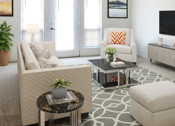 a living room with a couch and a chair and a table  at LakePointe Apartments, Batavia, Ohio