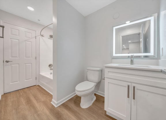 a bathroom with a toilet sink and shower  at The Vinings Apartments, Richmond, 23234