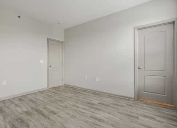an empty room with a door and a white wall at The Avenue at Polaris Apartments, Columbus, OH