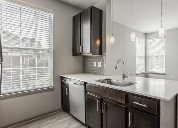 an empty kitchen with a sink and a window at The Avenue at Polaris Apartments, Columbus, OH