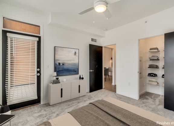a bedroom with a bed and a ceiling fan  at Uptown Square Apartments, Michigan, 48083