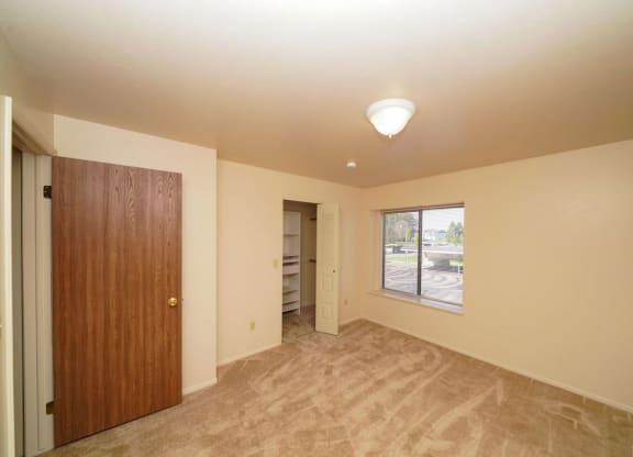 Bedroom with a walk-in closet with wardrobe organizers at Emerald Park Apartments in Kalamazoo, MI 49001