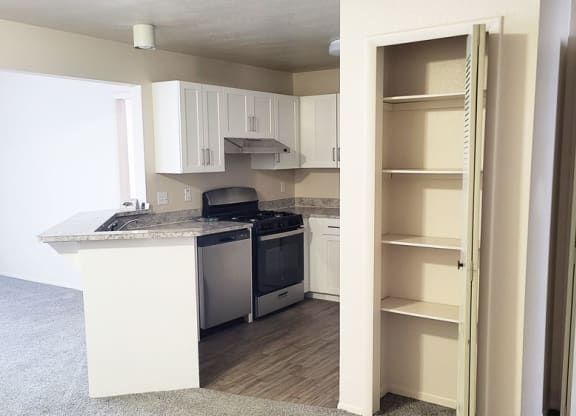 Renovated kitchen with white cabinets at Emerald Park Apartments in Michigan 49001