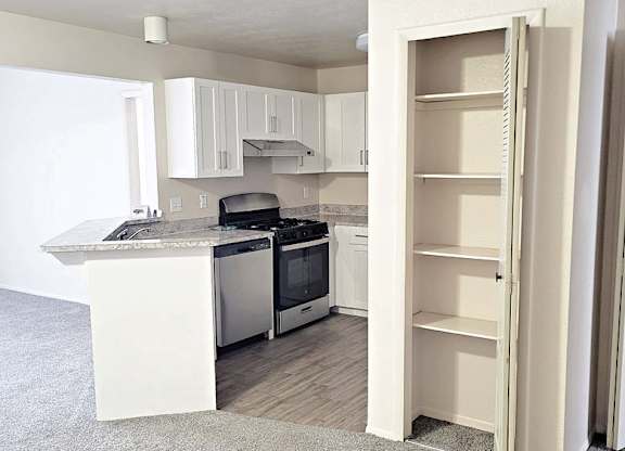 Upgraded kitchen with white cabinets at Emerald Park Apartments in Michigan 49001