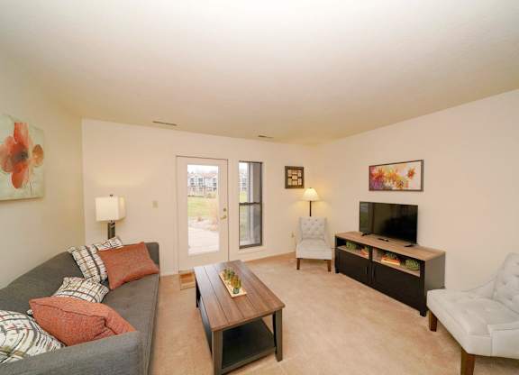 Living Room With French Door to Patio at Emerald Park Apartments, Michigan