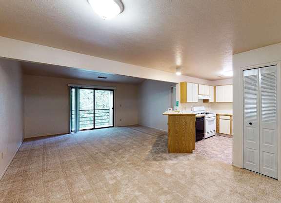 A dining and living room with access to a balcony at Emerald Park Apartments, Michigan