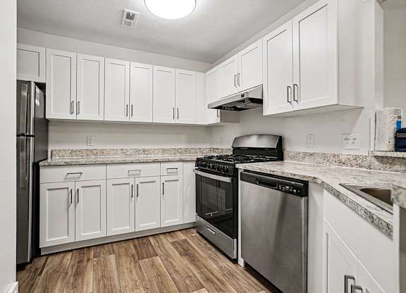 A kitchen with white cabinets and stainless steel appliances at Emerald Park Apartments, Kalamazoo, Michigan