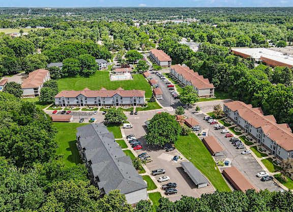 A bird's eye view of a residential area with apartments and cars at Emerald Park Apartments in Kalamazoo, MI