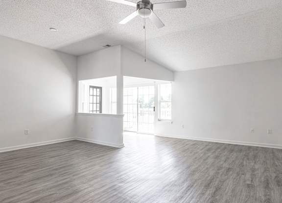 an empty living room with white walls and a ceiling fan at Latitudes Apartments, Indianapolis, IN, 46237