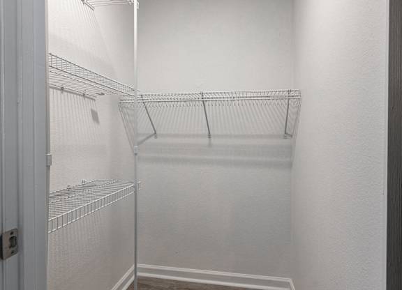 an empty walk in closet in a white room with white walls and a white door at Latitudes Apartments, Indianapolis, Indiana