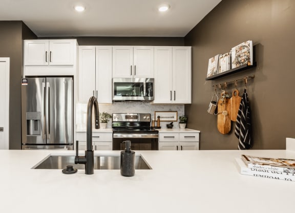 Kitchen With White Cabinetry And Appliances at Nuvo Flats, Merrillville, IN, 46410
