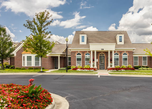 a large brick house with a driveway in front of it at The Avenue at Polaris Apartments, Columbus, OH