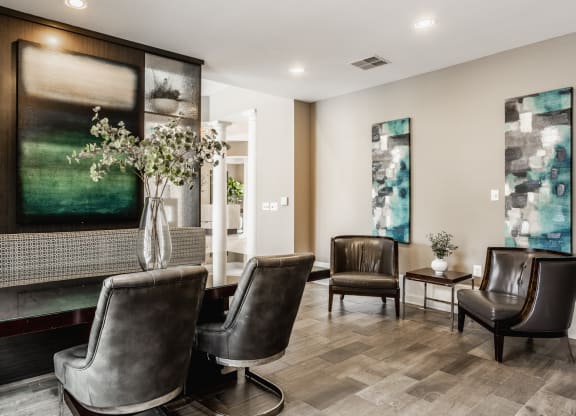 a living room with leather chairs and a fireplace at The Avenue at Polaris Apartments, Columbus, OH