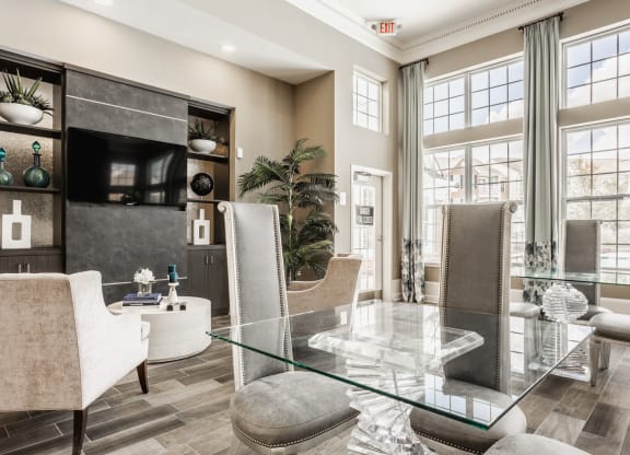 a living room with a glass table and chairs at The Avenue at Polaris Apartments, Columbus, OH