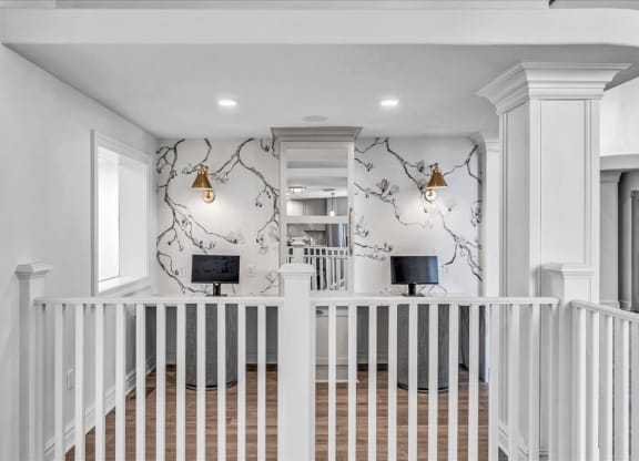 the entryway of a home with a white staircase and a wall with a wallpaper at The Vinings Apartments in Richmond, VA