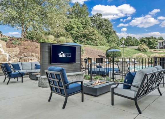 the clubhouse patio with chairs and a fire pit at The Vinings Apartments in Richmond, VA