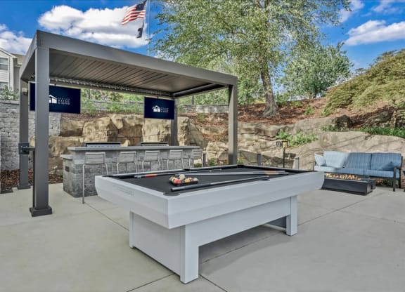 a billiards table in the backyard of a house at The Vinings Apartments in Richmond, VA