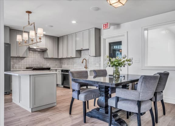 a kitchen and dining room with a table and chairs at The Vinings Apartments in Richmond, VA